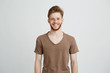 © Cookie Studio - Portrait of happy cheerful young man with beard smiling looking at camera over white background.