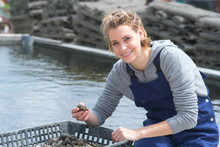 Happy Femake Worker At Fish And Mussel Farm