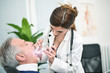 © Minerva Studio - Doctor checking a patients throat