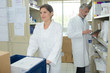 © auremar - smiling pharmacist and pharmacy technician in drugstore