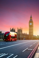  London, the UK. Red bus in motion and Big Ben, the Palace of Westminster. The icons of England