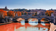 Skyline With Bridge Ponte Vittorio Emanuele II And Classic Architecture In Rome, Vatican City Scenery Over Tiber River. Autumn View With Red Foliage.