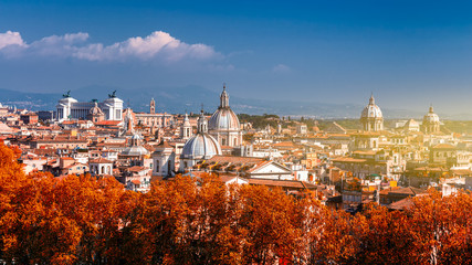Wall Mural - Panoramic autumn view over the historic center of Rome, Italy from Castel Sant Angelo. Red foliage.