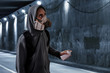 © fotokitas - Graffiti artist wearing respirator mask