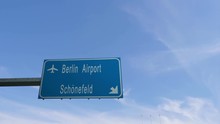 Berlin Airport Signboard Airplane Passing Overhead