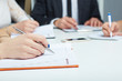 © cameravit - Female hand holding silver pen closeup. Woman writing plan, making notes on business meeting.