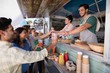 Waitress and waiter giving juice to customer at counter