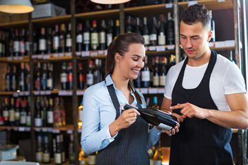 Wall Mural - Young man and woman working at cafe
