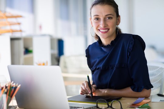 Female executive working over laptop 