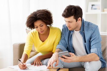 Canvas Print - couple with papers and calculator at home