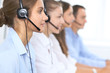 © rogerphoto - Call center operator in headset while consulting client. Telemarketing or phone sales. Customer service and business concept