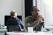 © Drobot Dean - Thoughtful african man sitting at his desk