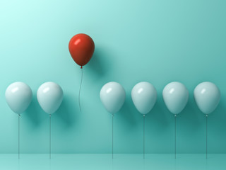 stand out from the crowd and different concept , one red balloon flying away from other white balloo