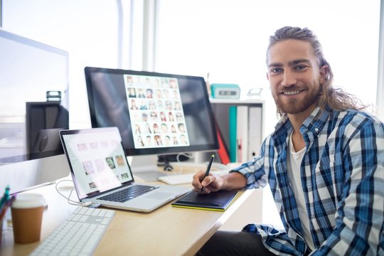 Portrait of male executive sitting at his desk