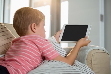 Boy using digital tablet in the living room