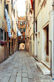 Fototapeta Uliczki - Traditional street view of old buildings in Venice, ITALY