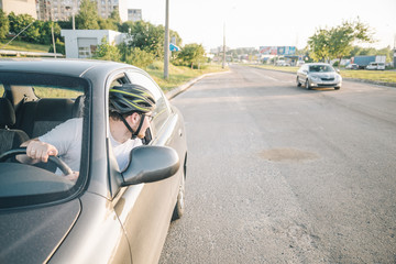 Wall Mural - man driving car in helmet with horror on her face