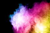 Fototapeta Tęcza - Launched colorful powder, isolated on black background