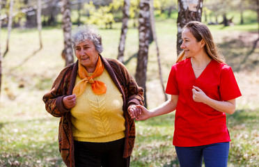 Elderly woman and young caregiver