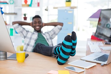 Wall Mural - Male executive relaxing at his desk in office