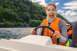 © bint87 - Portrait of young and attractive woman close up driving the motorboat, Norway. She is enjoying the sunny day.