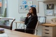 © Wavebreak Media - Female executive talking on mobile phone in office
