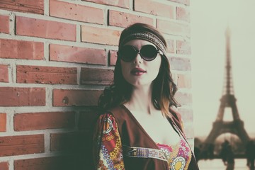 Portrait of Young hippie girl near brick wall