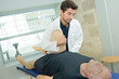 © auremar - doctor is stretching mans leg on physiotherapy session