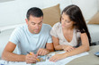 © auremar - young couple looking for plans of new house