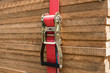 red ratchet strap fixing wood boards / wooden planks