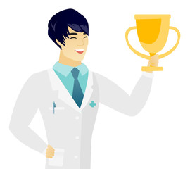 Sticker - Young asian doctor holding a golden trophy.