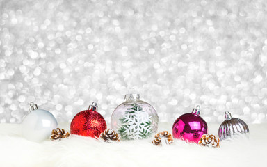 Aufkleber - christmas decoration ball on white fur at silver bokeh light background,holiday greeting card