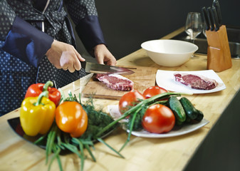 Wall Mural - Man cuts the meat with a knife