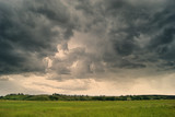Fototapeta Na sufit - Storm cyclone over summer fields, hills and forests