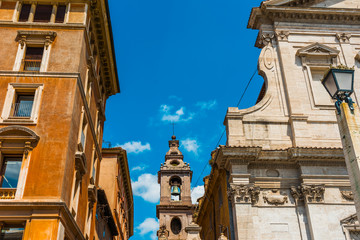 church tower in the middle of buildings at rome