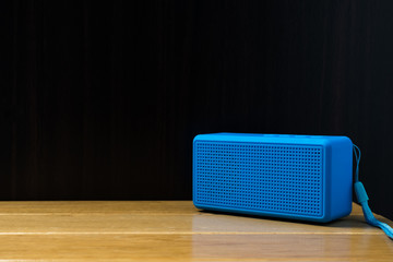 blue speaker on the table.