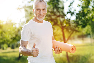 Wall Mural - Positive aged smiling getting ready for sport exercises