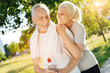 © zinkevych - Positive retired smiling couple resting in the park after jogging