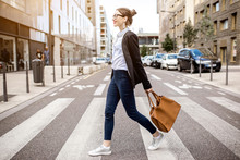 Young Businesswoman Crossing The Street At The Modern Office District In Lyon City