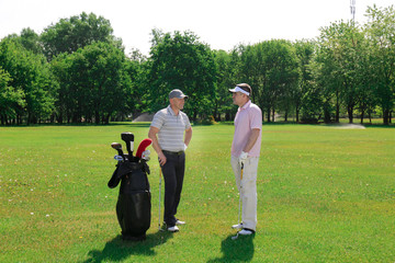 Canvas Print - Young men on golf course in sunny day