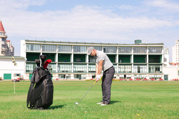 Canvas Print - Young man playing golf on course in sunny day