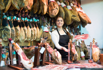 Wall Mural - Happy woman offering tasty jamon