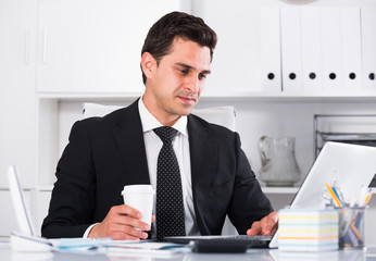 Respectable and cheerful businessman in office