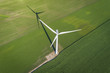 Wind turbine in a green field, top aerial view