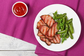 Wall Mural - grilled slices of meat and green peas