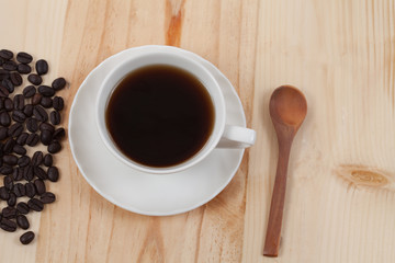 White Cup of coffee on Pine wood desktop table on top