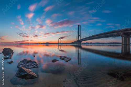 Sunset in the city with a bridge Poster