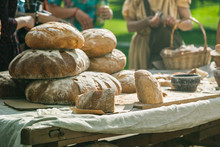 People Choosing Bread On The Table Of Bread Seller. Outdoors Summer Trading