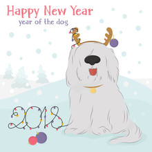 Christmas Card With Large, Shaggy Dog Breed Bobtail With Decorative Reindeer And Christmas Balls On A Blue Background With Snow.