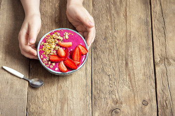 Wall Mural - Breakfast smoothie bowl in hands